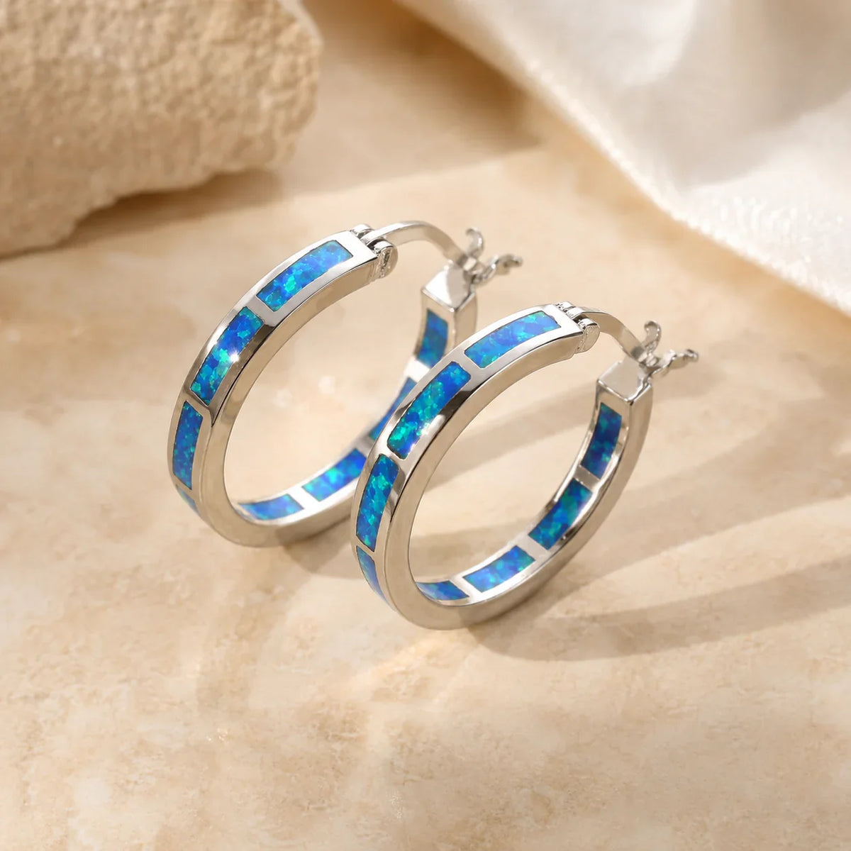 Elegant Halo Earrings Adorned with a Blue Fire Opal