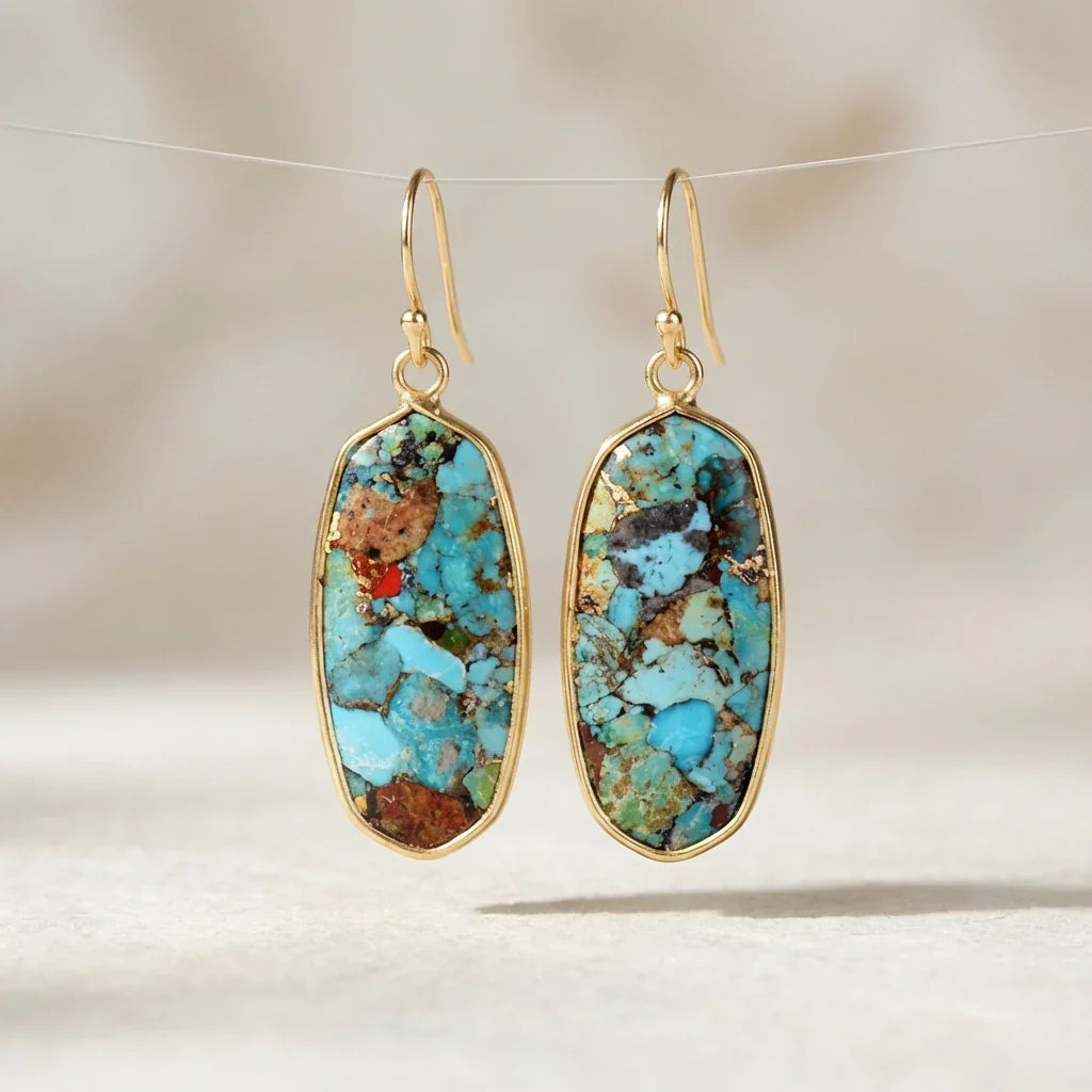 Elongated turquoise-blue and brown mosaic earrings with slim gold-tone borders and hooks.
