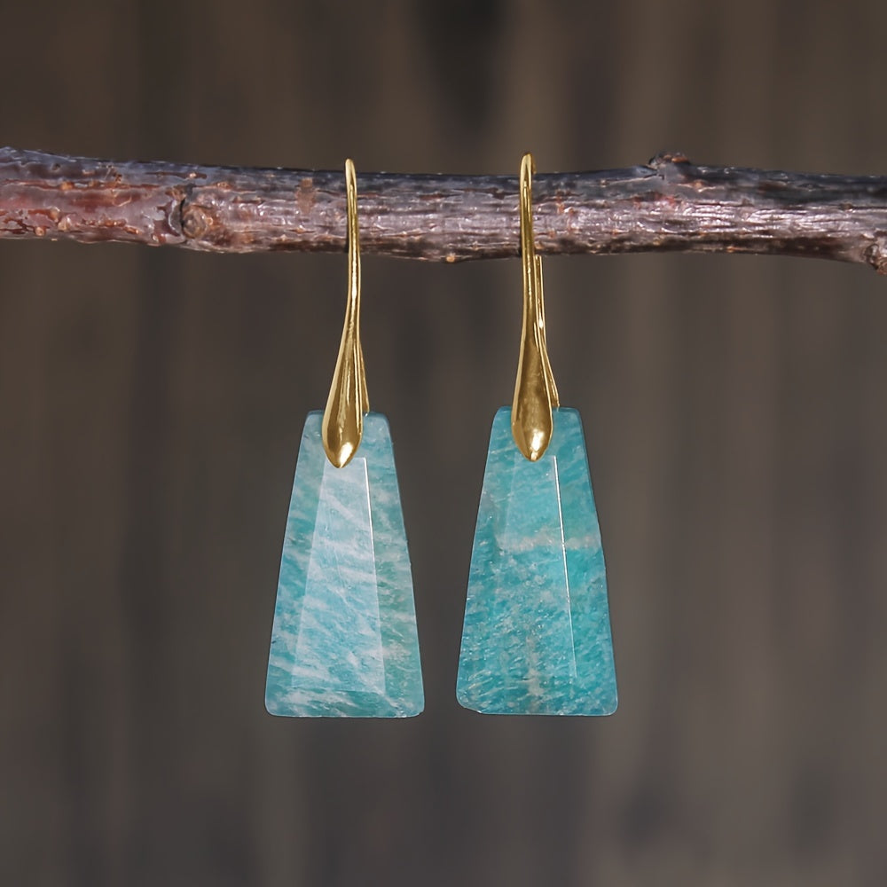 Aqua-blue tapered geometric earrings with pale patterning and long gold-tone hooks.