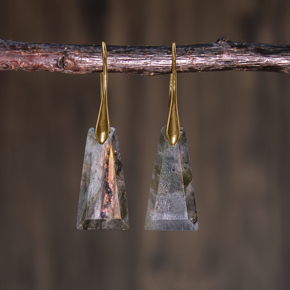 Gray-green tapered geometric earrings with mottled patterning and long gold-tone hooks.