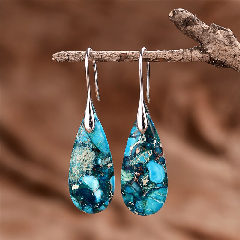 Elongated turquoise-blue mosaic teardrop earrings with long silver-tone hooks.