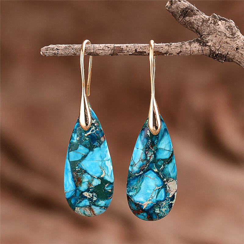 Elongated turquoise-blue mosaic teardrop earrings with long gold-tone hooks.
