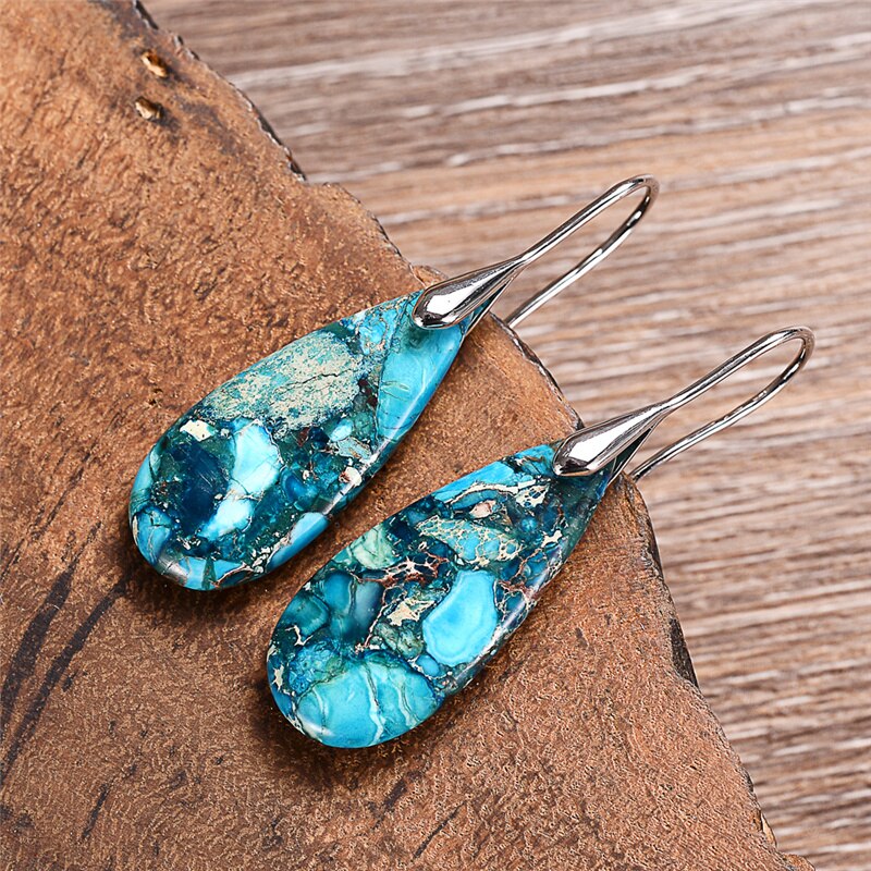 Elongated turquoise-blue mosaic teardrop earrings with long silver-tone hooks.