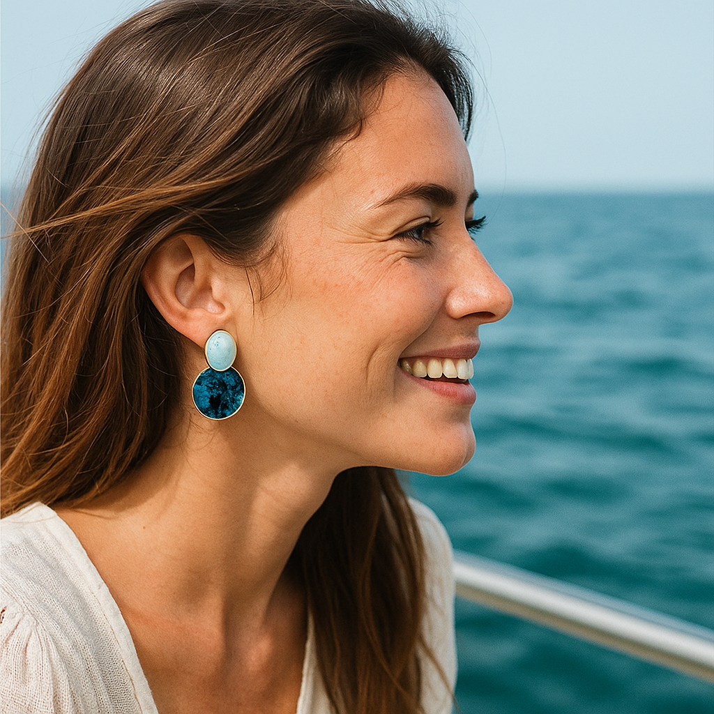 Nerissa blue round drop earrings worn by a woman