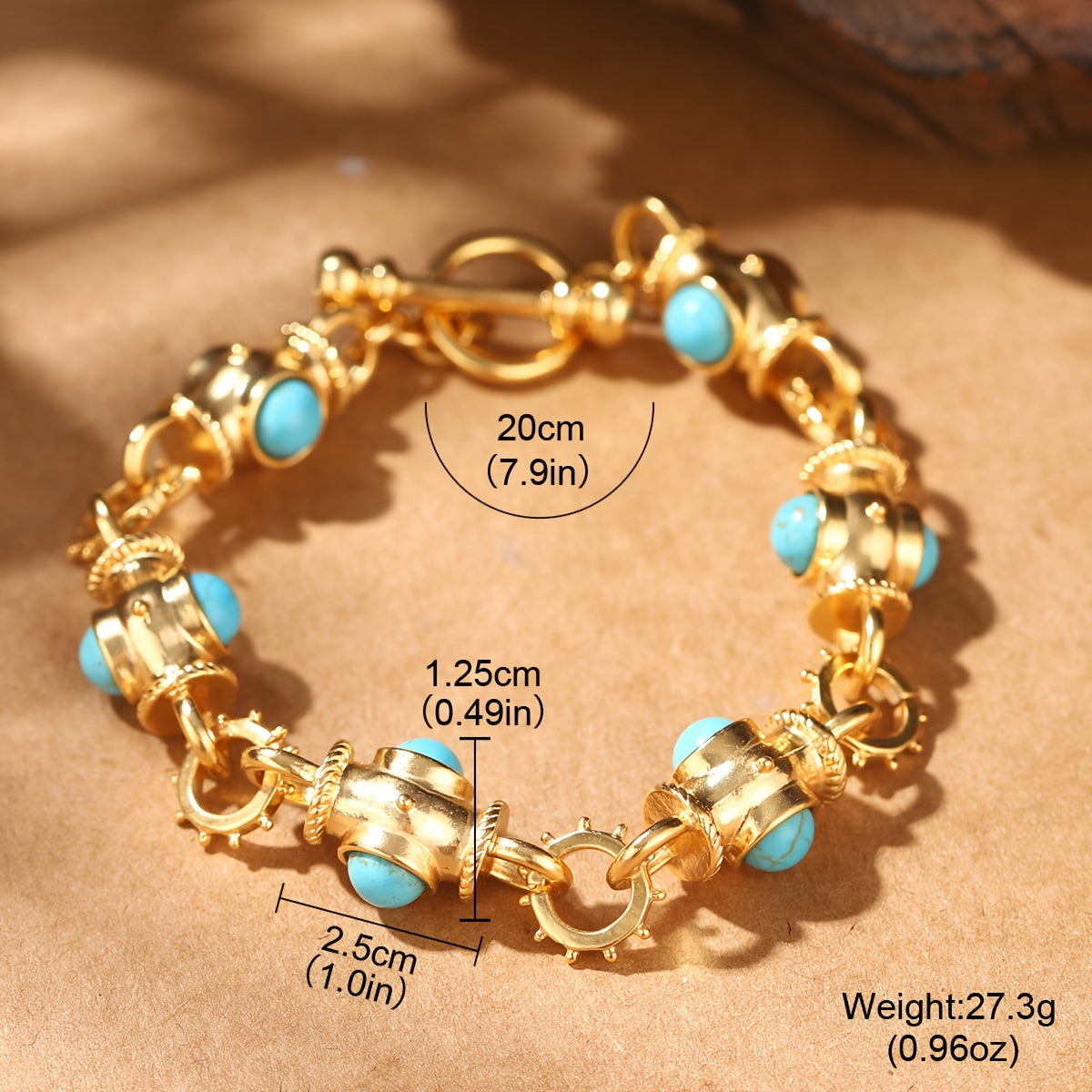 Gold-tone toggle bracelet with turquoise-colored accents; source size illustration labels 20 cm length.