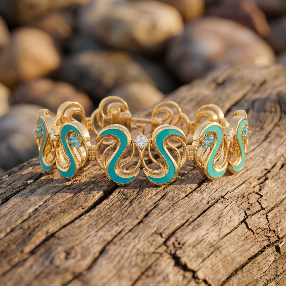 Gold-tone cuff bracelet with repeated open scroll shapes, aqua sections, and small icy blue accents.