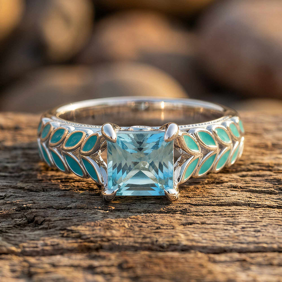Ring with a square icy blue faceted center and aqua leaf-shaped accents along the band.