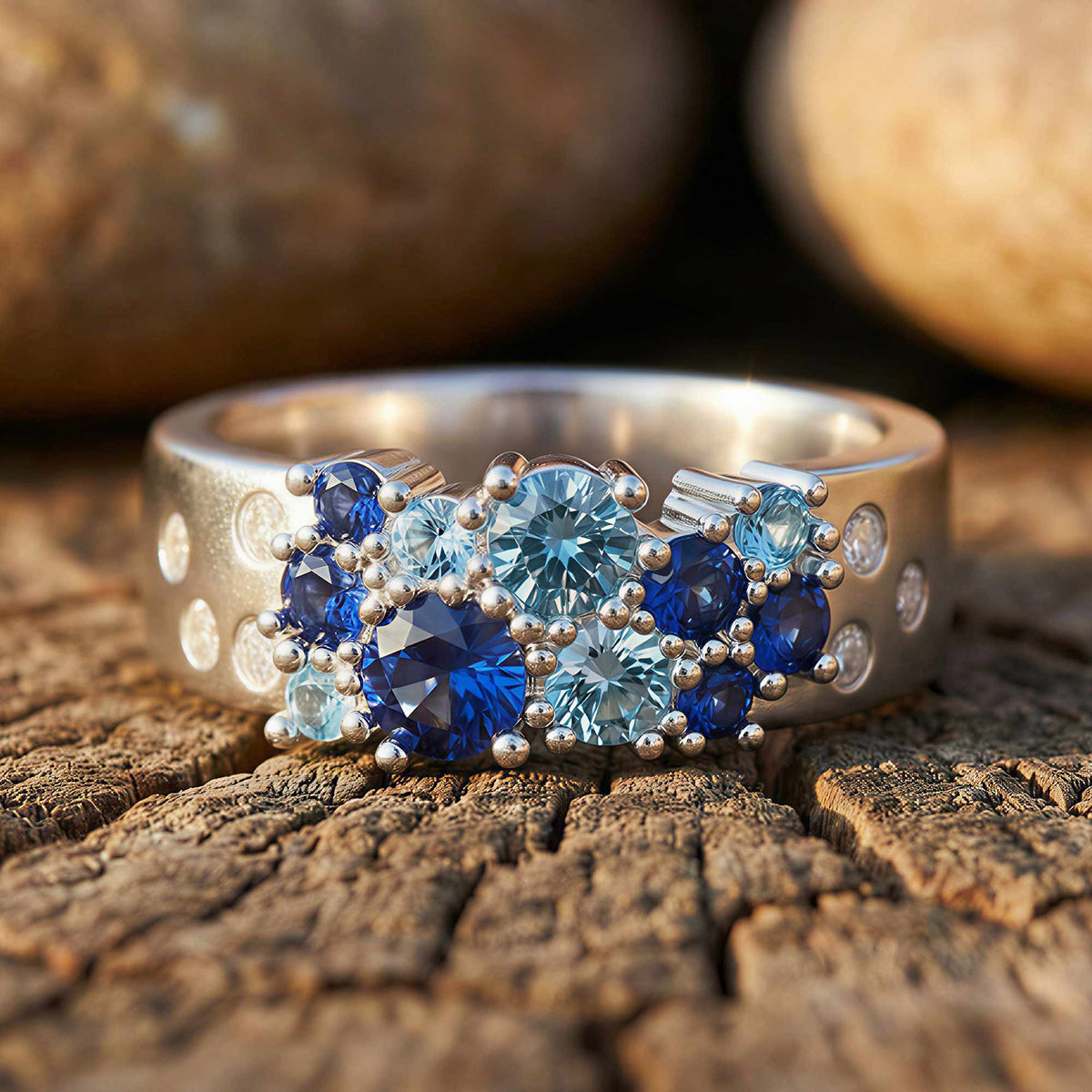 Cluster ring with deep-blue and icy blue faceted accents arranged across a textured band.