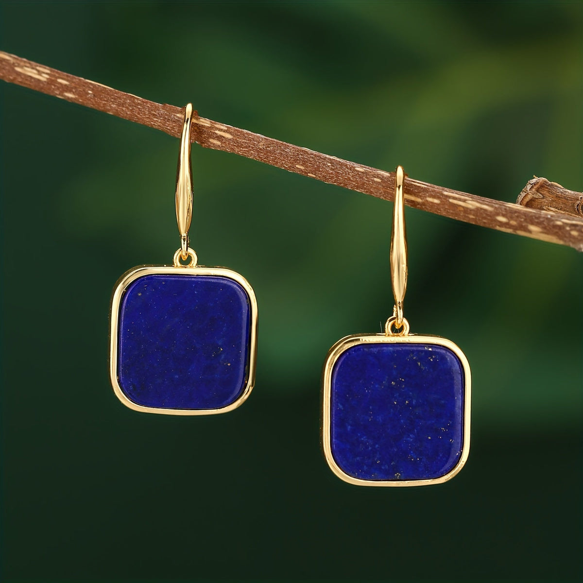 Dark-blue square drop earrings with rounded corners and gold-tone frames and hooks.