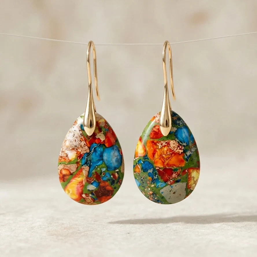 Multicolor mosaic teardrop earrings with blue, green, orange, and red areas and gold-tone hooks.