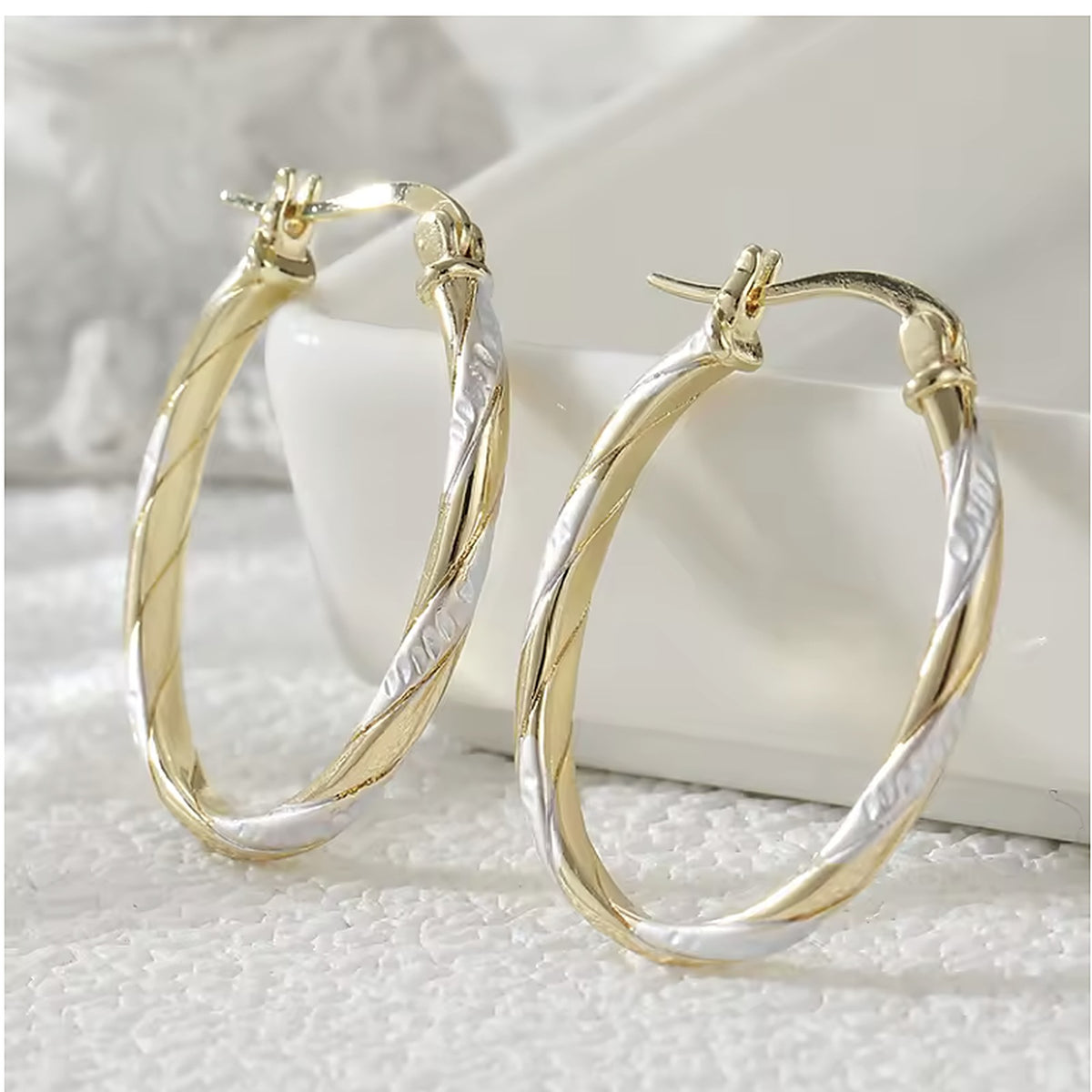 Two-tone oval twist hoop earrings