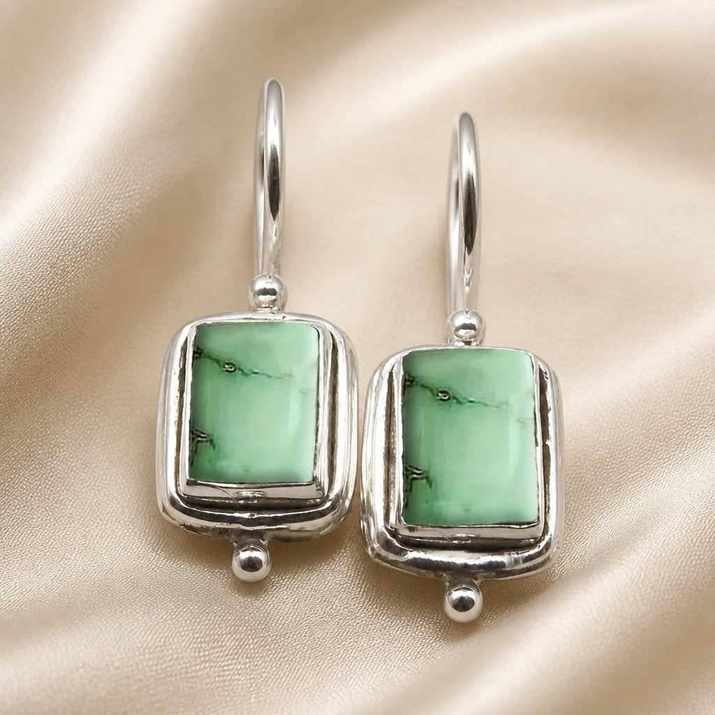 Mint-green resin rectangle earrings with layered silver-tone frames and hook fittings.