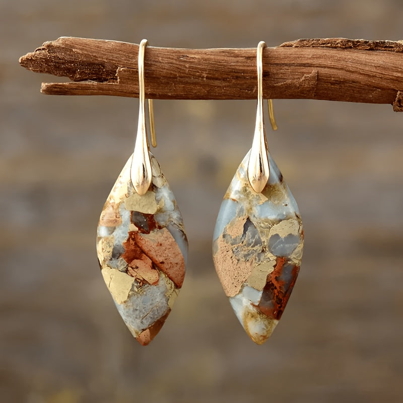 Marquise earrings with aqua, beige, and brown patchwork-like patterns and long gold-tone hooks.