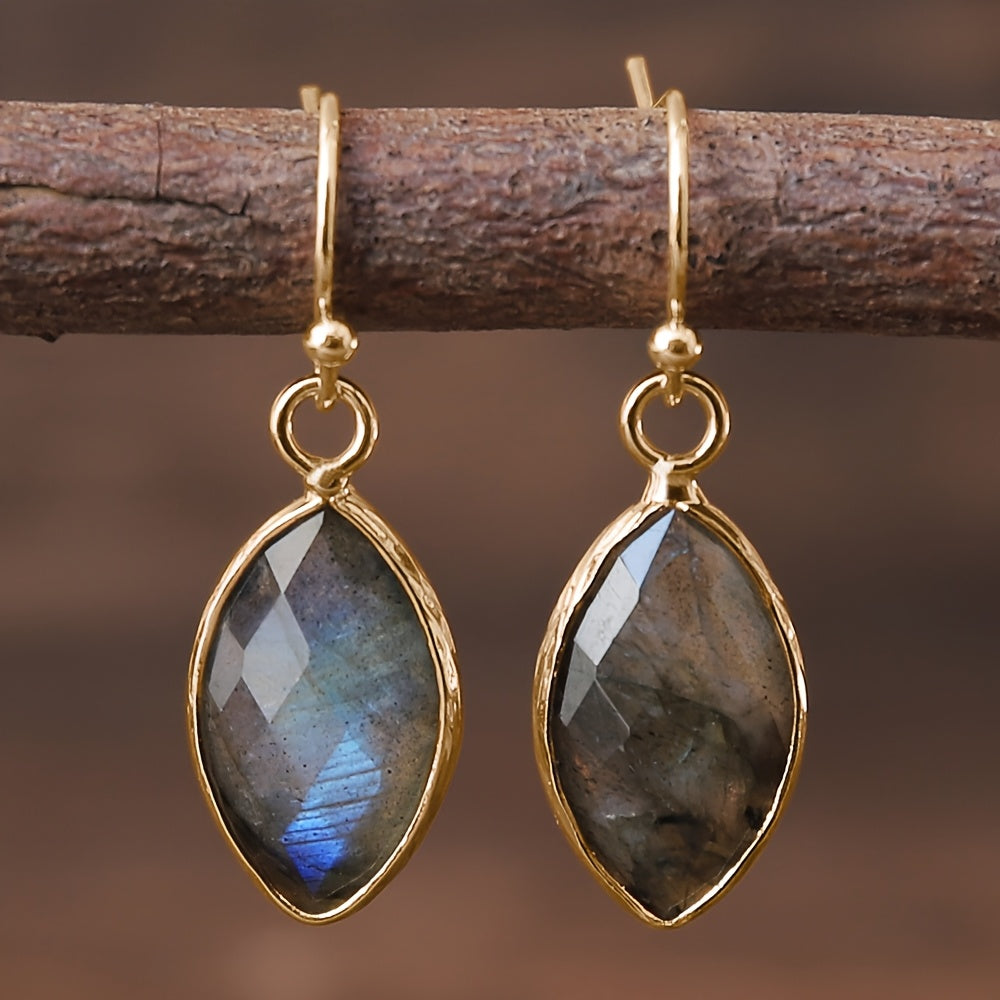 Faceted blue-gray pointed oval earrings with blue reflections and slim gold-tone frames.