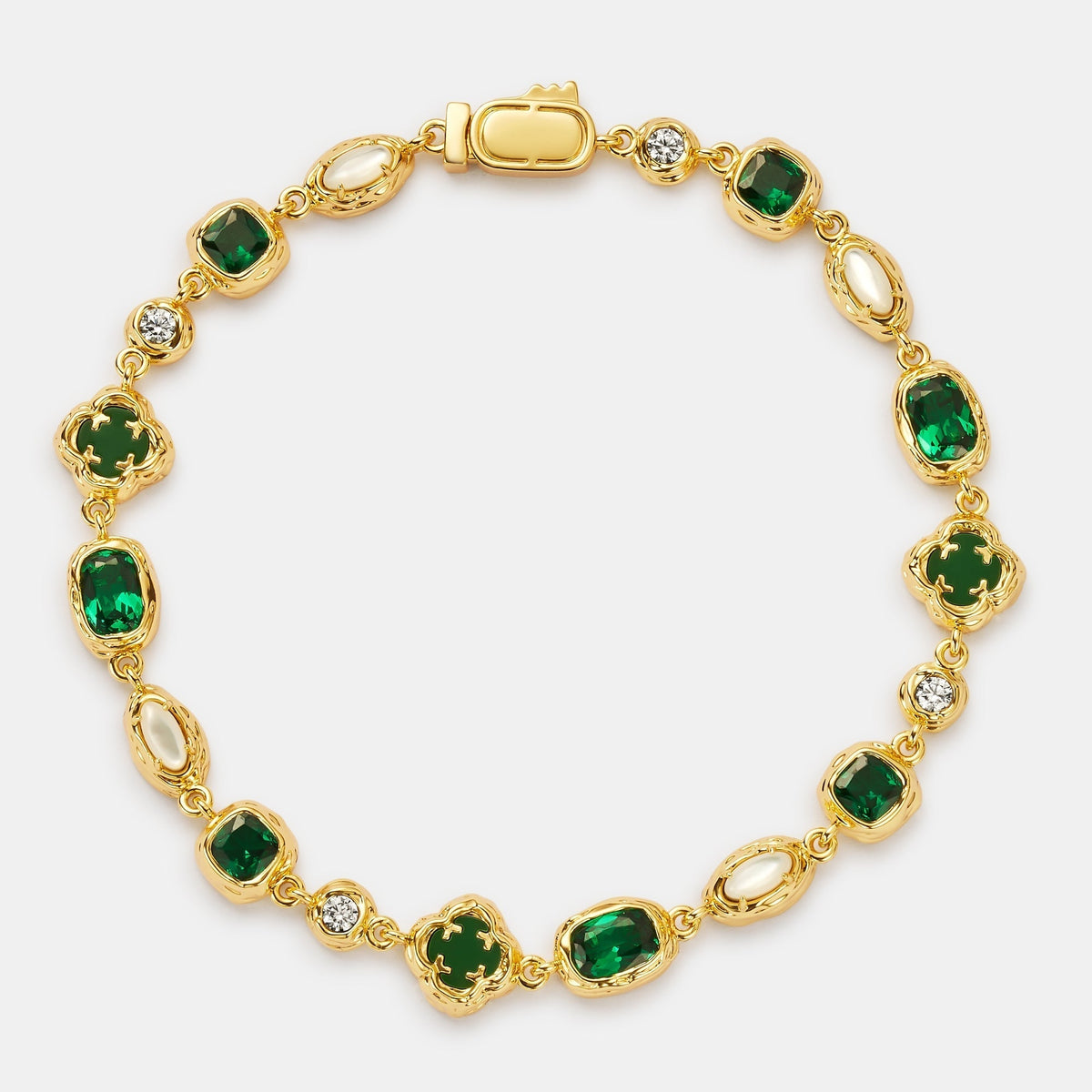 Gold-tone linked bracelet with green centers, pale oval accents, and small clear accents.