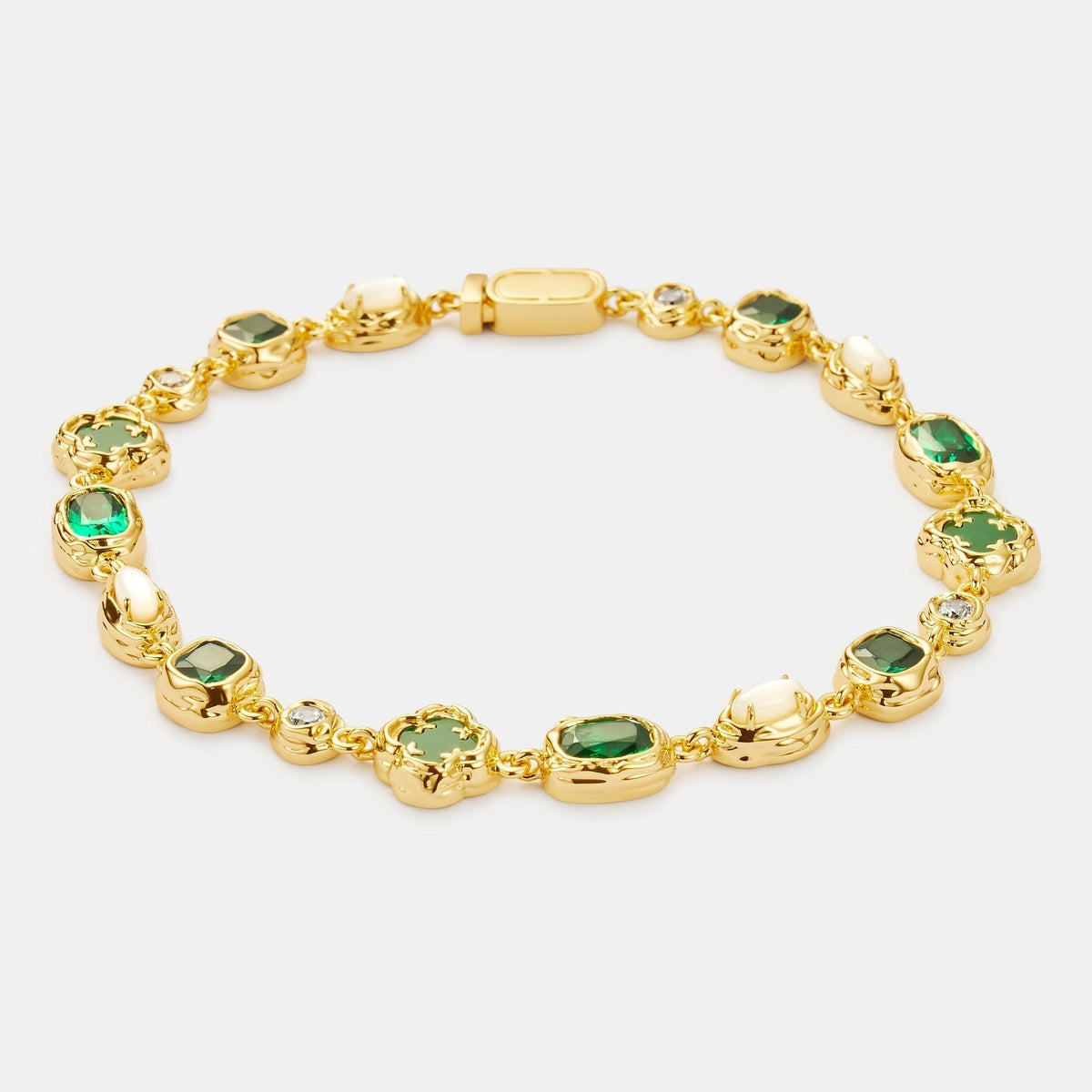 Gold-tone linked bracelet with green centers, pale oval accents, and small clear accents.