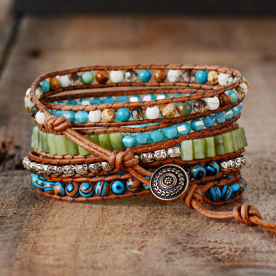 Back of a multicolor bead wrap bracelet showing brown cord, varied bead rows, and a decorative button.