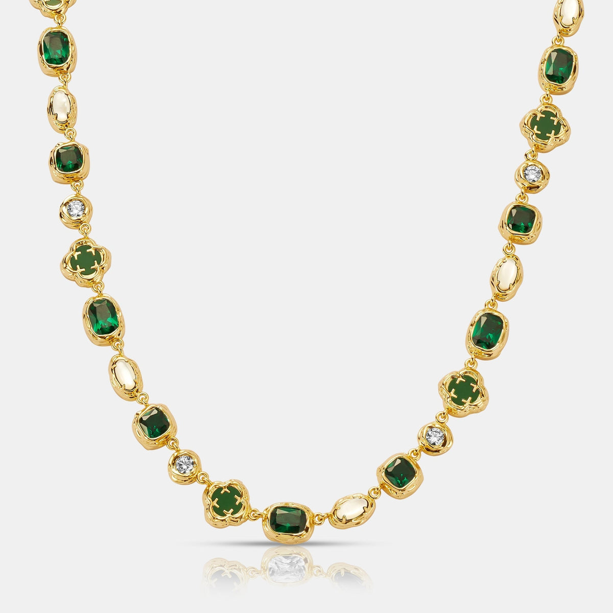 Gold-tone linked necklace with green centers, pale oval accents, and small clear decorative details.