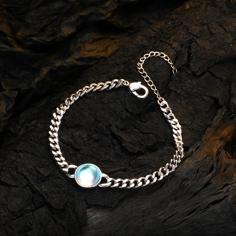 Silver-tone chain bracelet with a round pale iridescent center, clasp, and extension chain.