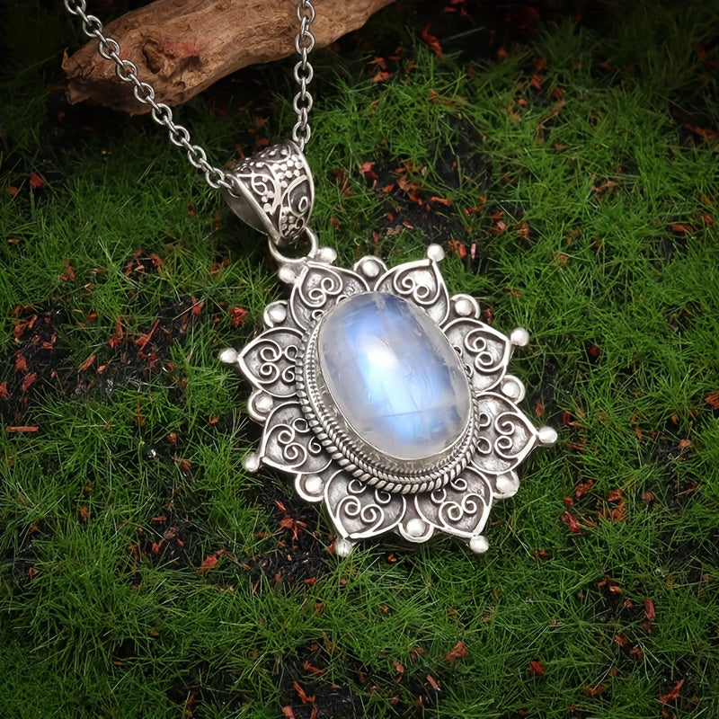 Pale blue-white oval pendant surrounded by an ornate silver-tone floral frame on a matching chain.
