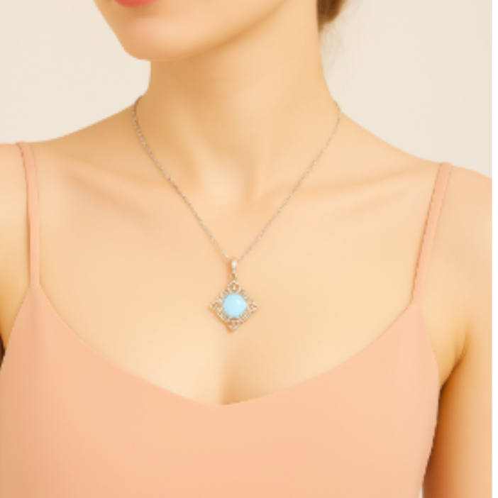 Model wearing a silver-tone pendant necklace with a pale-blue round center and open scrollwork frame.