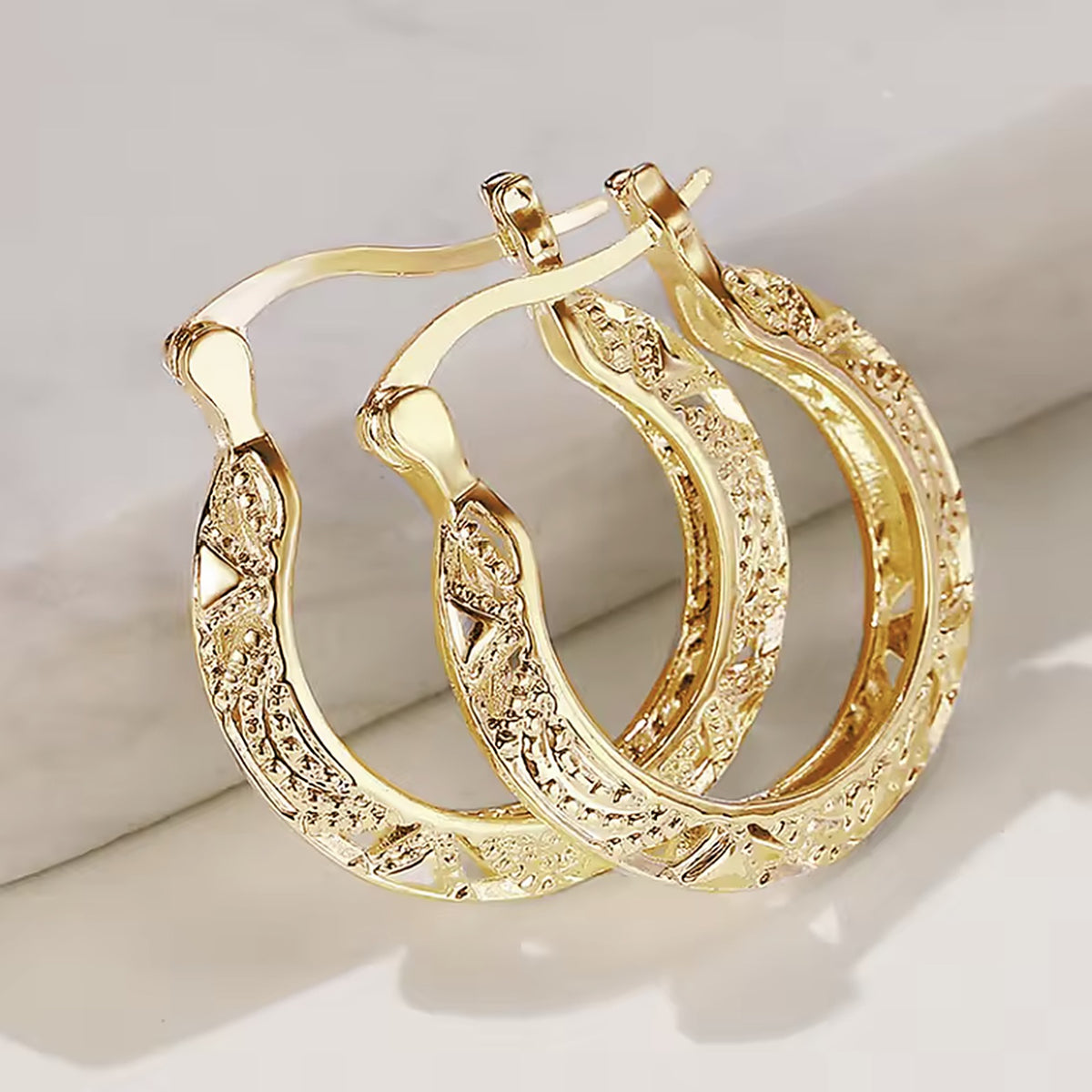 Filigree hoop earrings in gold