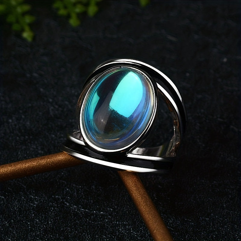 Large oval blue-reflective ring with a silver-tone border and sweeping open side bands.