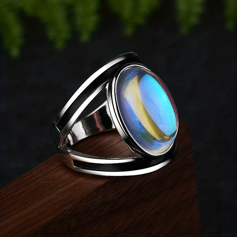 Large oval blue-reflective ring with a silver-tone border and sweeping open side bands.