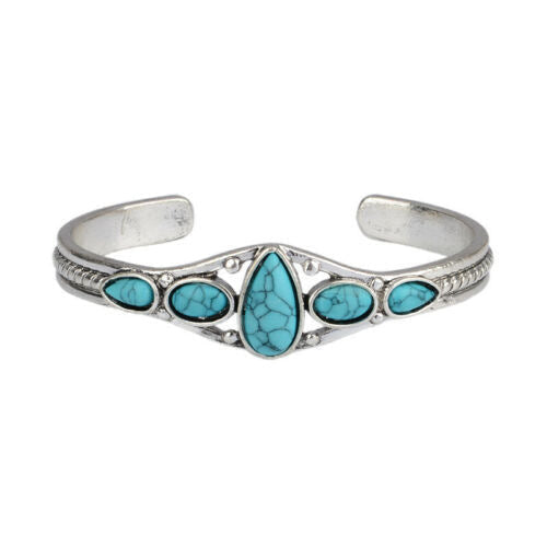 Silver-tone open cuff with a turquoise-colored central teardrop and four smaller side accents.